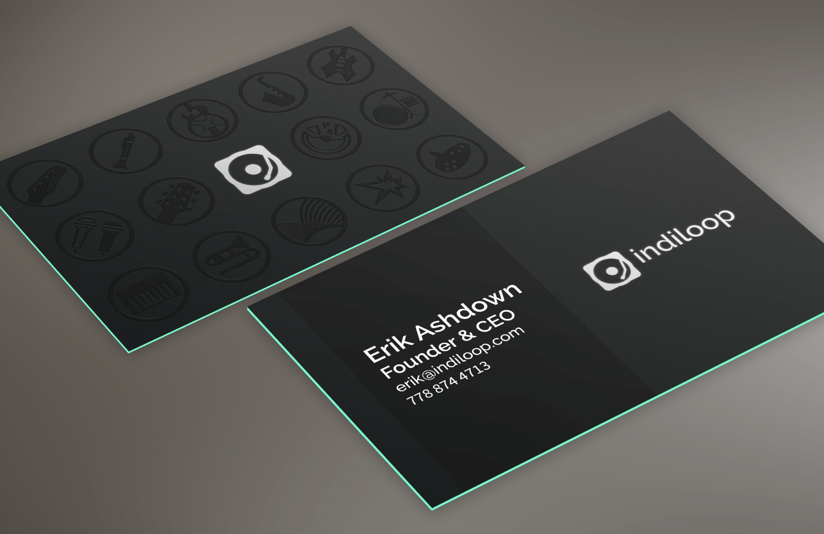 Indiloop black business cards with an embossed circular pattern, white logo, and turquoise edges